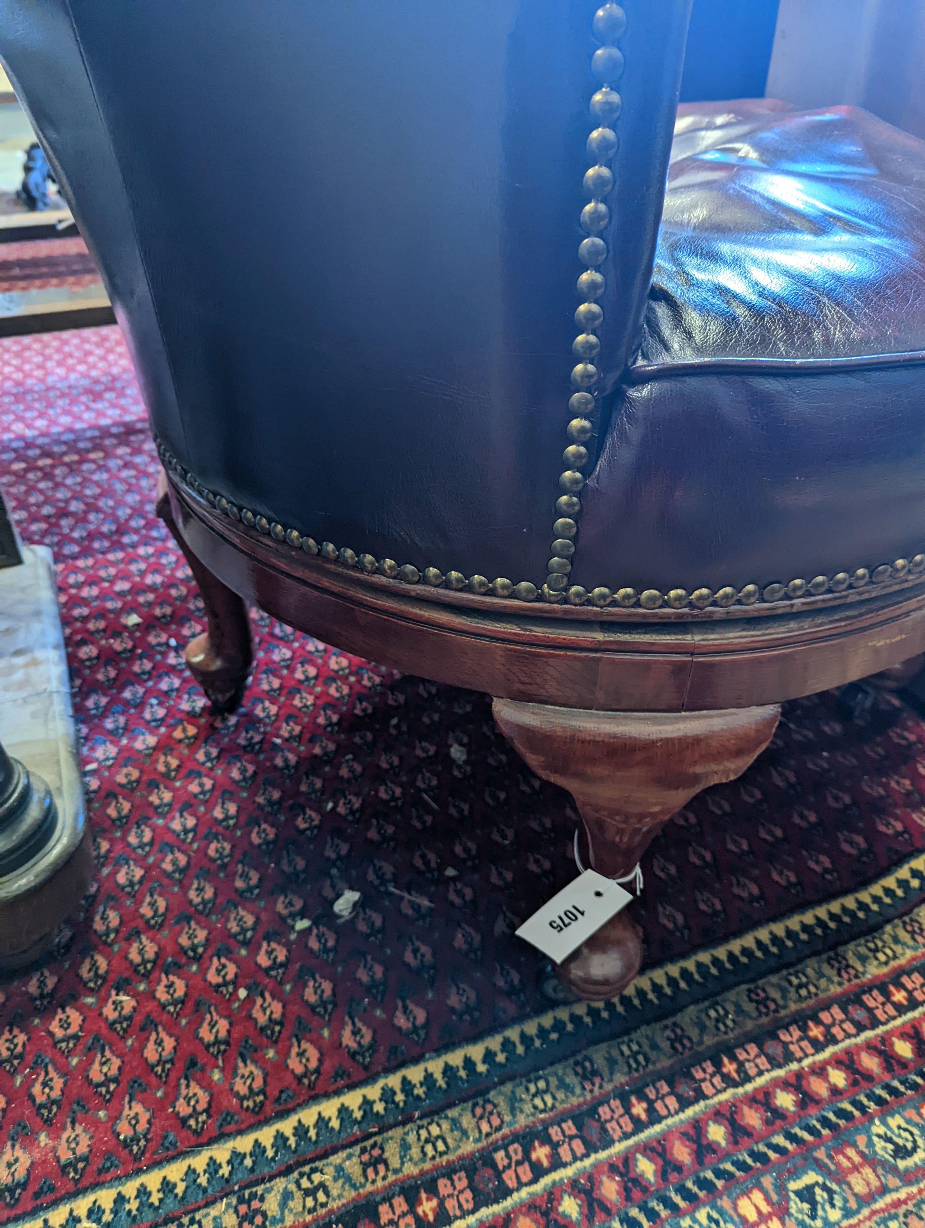 An early 20th century oak and burgundy leather tub framed swivel desk chair, width 70cm, depth 60cm, height 82cm